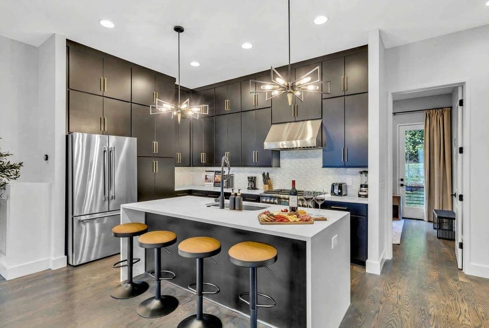 Explore this luxurious kitchen, perfect for gatherings and late-night snacks. With stylish decor and ample counter space, it's an ideal spot for coffee before adventures in Downtown Nashville—great for bachelorette parties or family reunions!