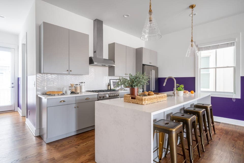 Kitchen features an island with a breakfast bar and modern appliances. (Twain)