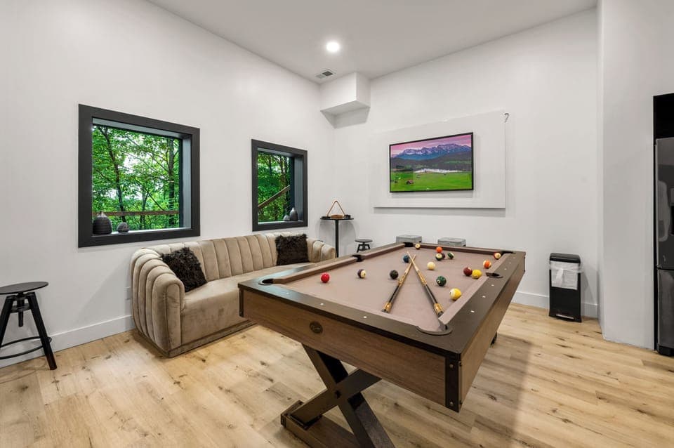 Lounge area with a kitchenette, bistro seating, and a pool table.