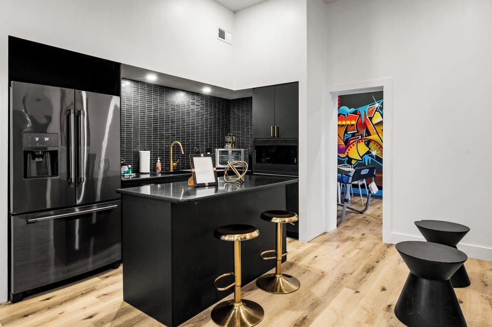 Shared kitchenette with barstool seating, pool table, and seating - perfect for relaxed gatherings!