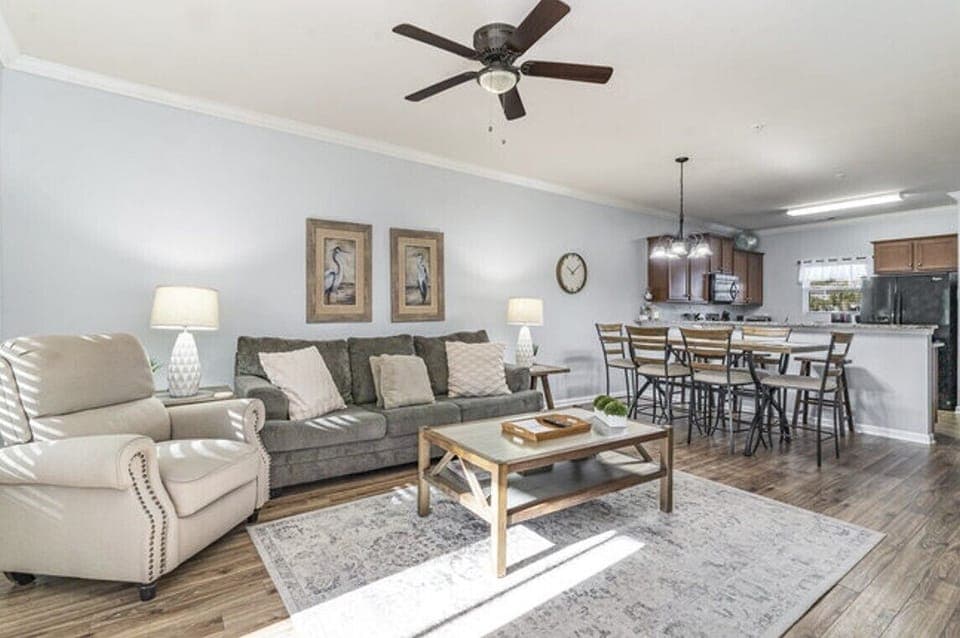 Open concept living room with cozy seating and a modern touch.
