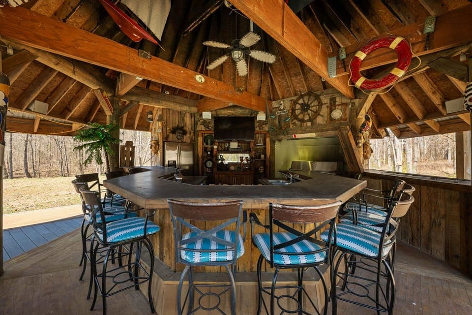 Sizzle, sip, and relax! Our poolside tiki bar comes complete with a BBQ grill, refrigerator, TV, and ample seating so you can host unforgettable gatherings in true tropical style.