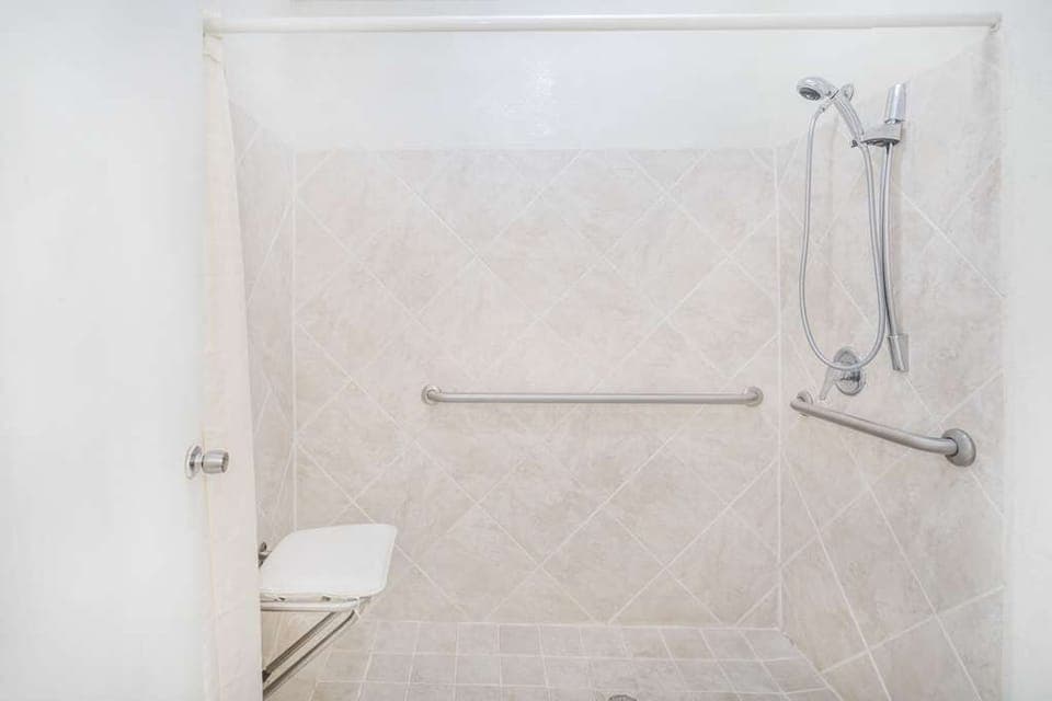 Refresh comfortably in a spacious roll-in shower with grab bars.