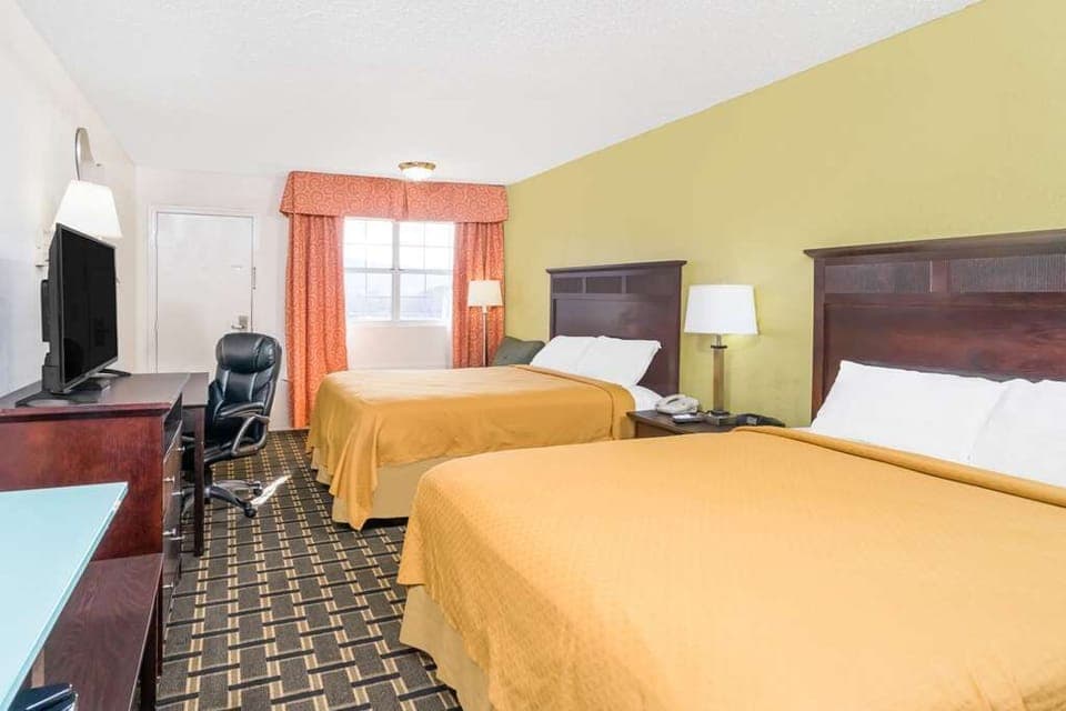 Spread out together in a sunny room with two plush beds.
