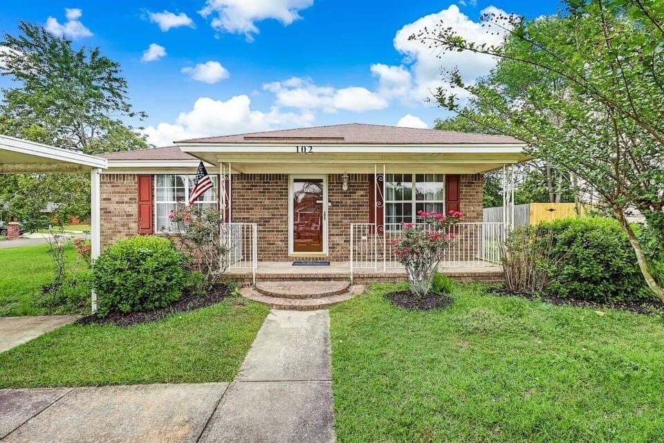 Front exterior view with a walkway leading to the entrance and a well-kept lawn.