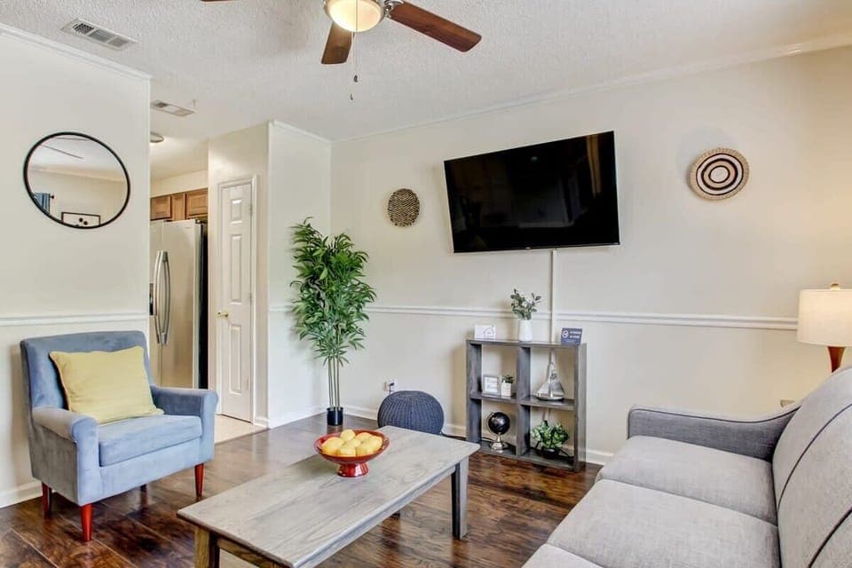 Another angle of the inviting living area showing the open layout and hardwood floors.