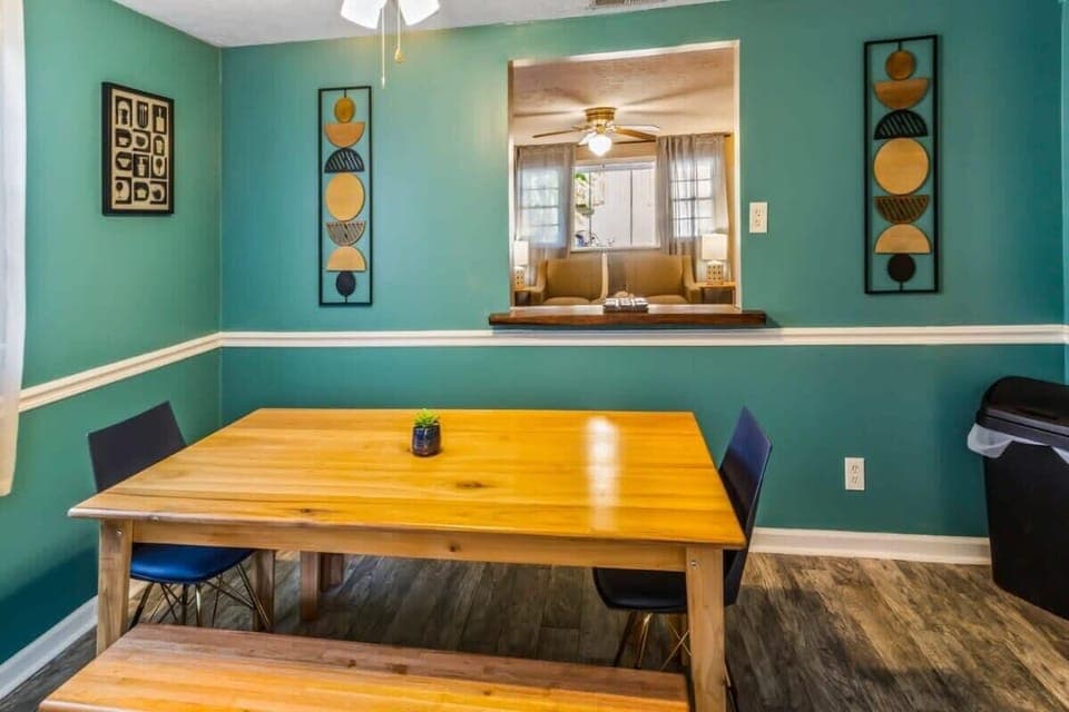 Open dining area with a yellow table and a view into the living space.