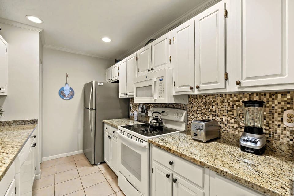 Whip up culinary delights in this modern kitchen with elegant granite counters