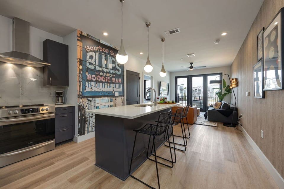 Unit 1: Fully equipped kitchen stocked with your basic cooking essentials. Includes stainless steel appliances, kitchen island, coffee machine, and toaster.
