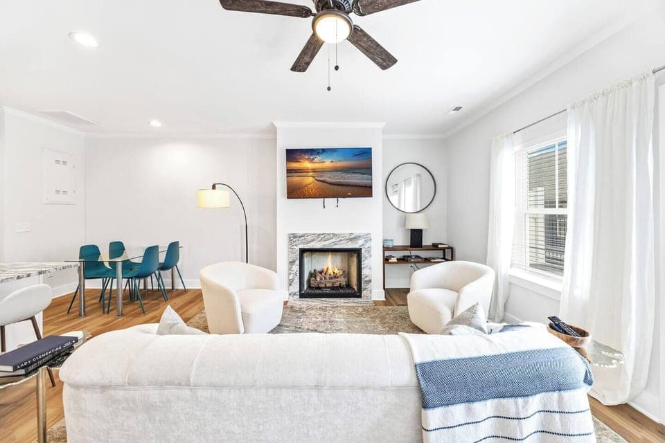 Sink into plush seating and unwind by the modern fireplace, with natural light streaming in from every angle.