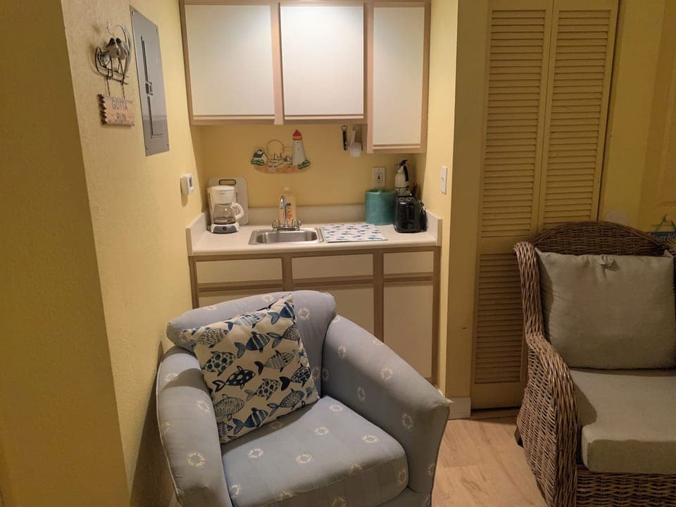 2 big comfortable chairs-blue chair swivels-whicker chair waterproof cushions.