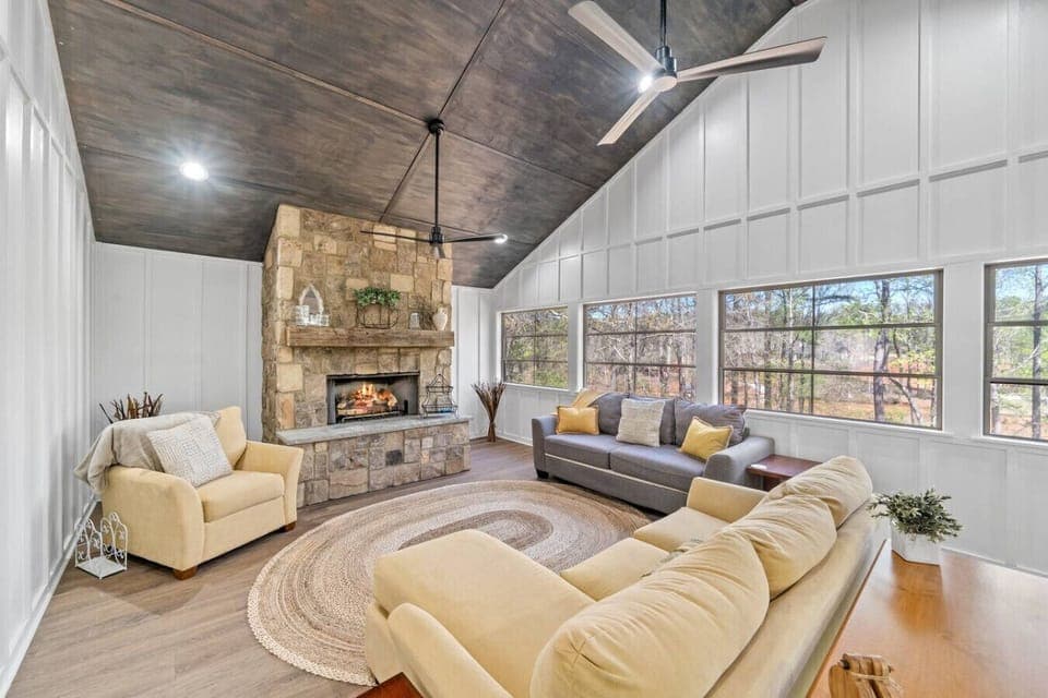 The four season room with fireplace and amazing views of the water.  This room is huge and a great place to enjoy coffee, play games with the family or just enjoy the fire.  Kids will love the children`s corner too filled with books and games.