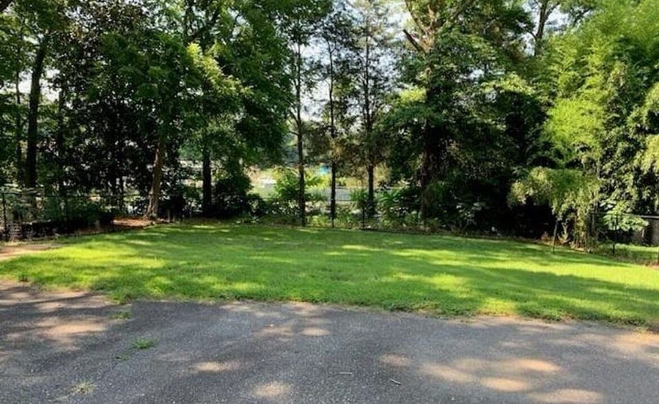 Backyard backs up to YMCA tennis courts