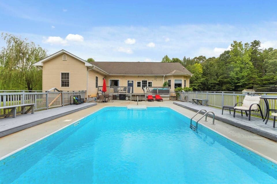 Private backyard pool oasis with expansive sun deck, surrounded by forest and bordering a nature reserve. Ideal for summer escapes, family vacations, and group retreats with unmatched privacy and peaceful surroundings.