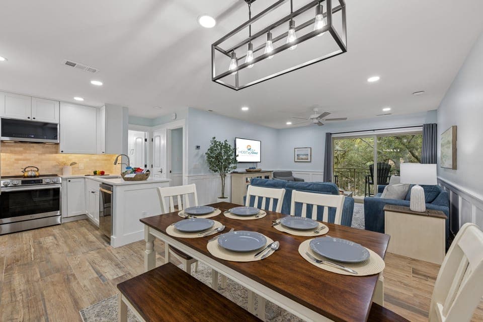 Open-concept living area with multiple couches, arm chair, and a Smart TV