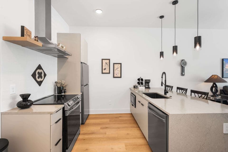 Clean, modern lines meet Nashville soul in this sleek kitchen setup.