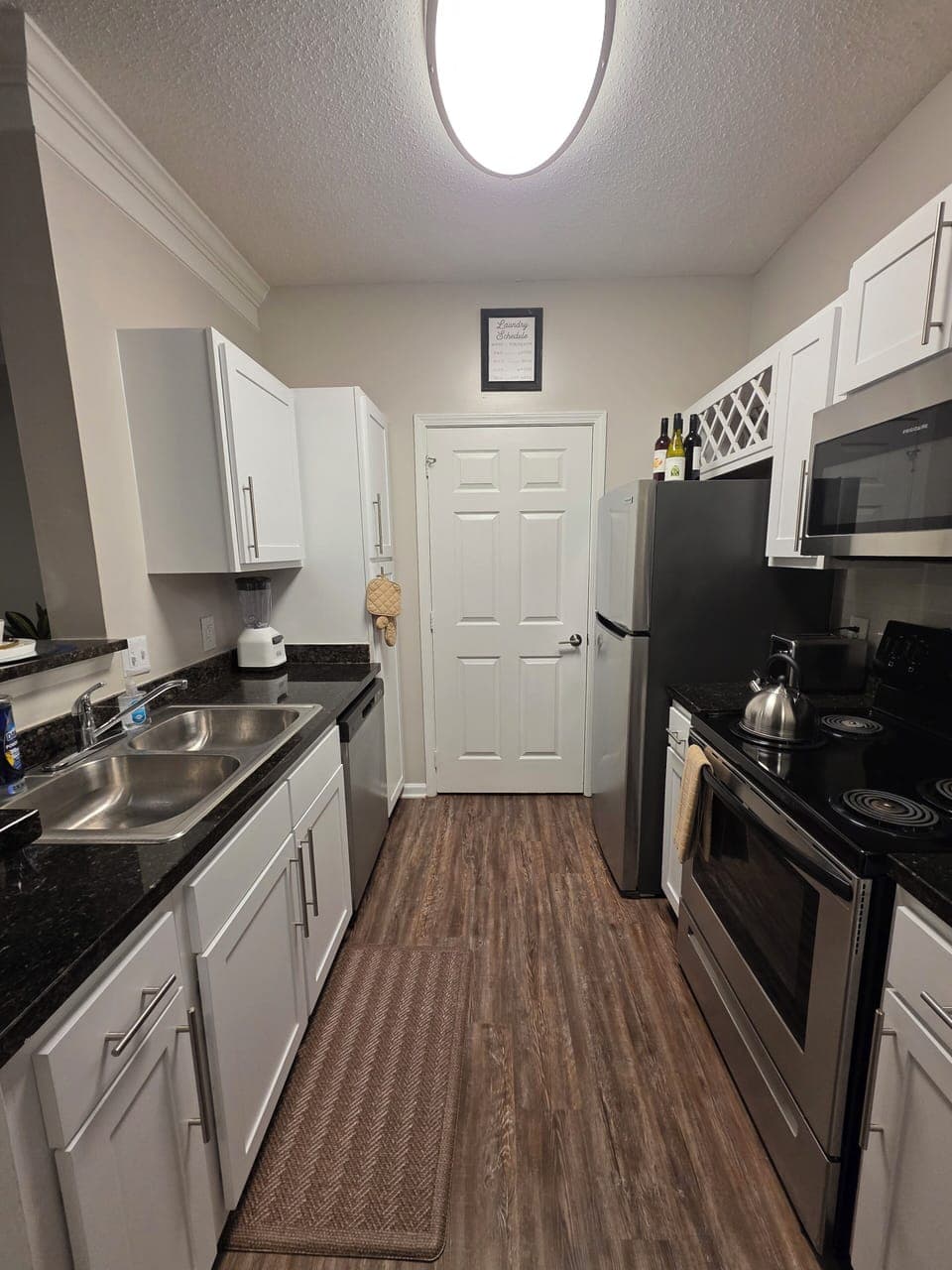 Fully stocked kitchen with laundry just behind the door.