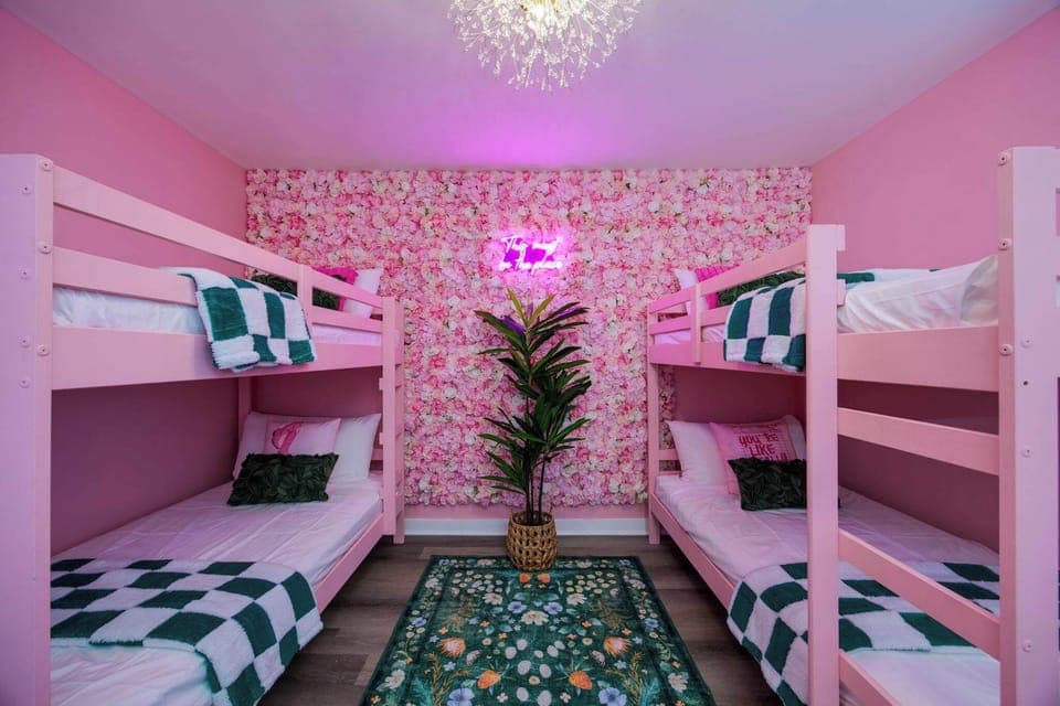 Instagram-worthy fun with pink decor and vibrant floral walls for unforgettable stays!