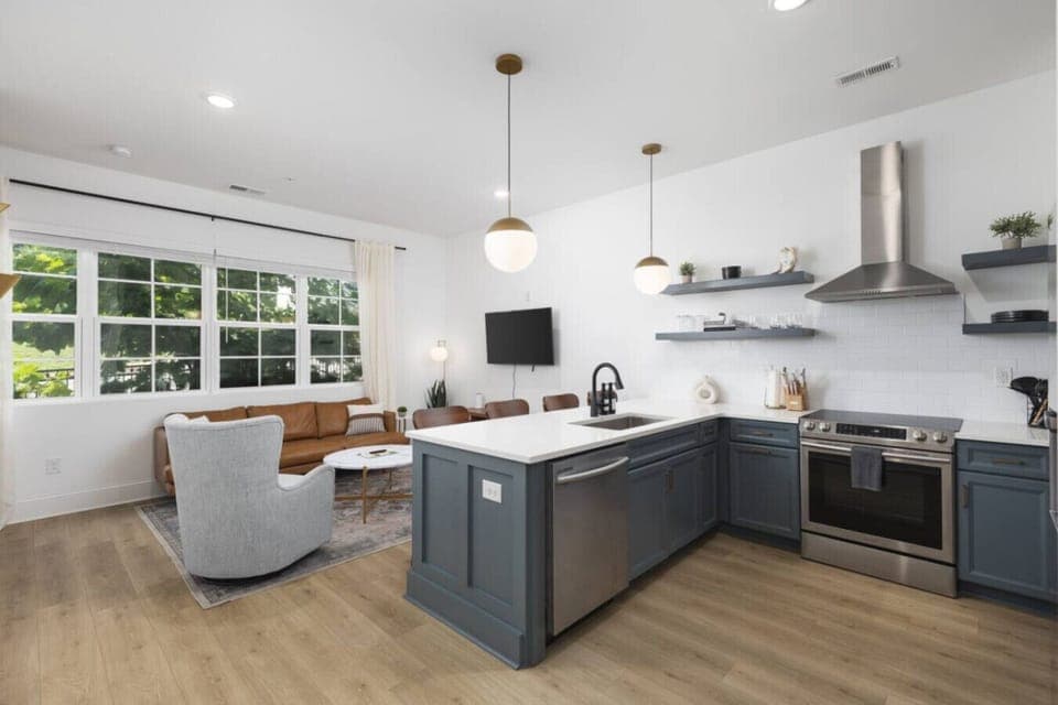 Condo 1 - Fully-stocked kitchen with high-end appliances and seating for 4 at the kitchen counter.