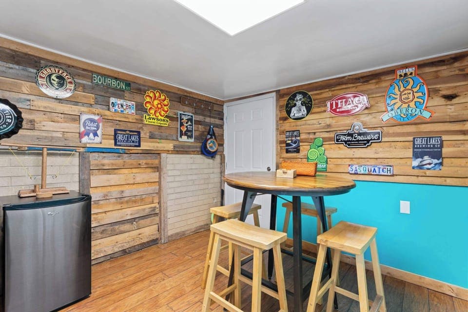 Entertainment space with bar seating, highboy table, mini fridge, and smart TV. Perfect for a fun evening hangout