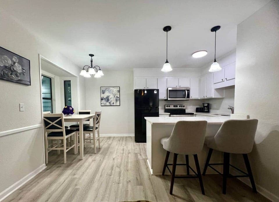 Gather for meals in the bright dining area, featuring a farmhouse-style table, modern lighting, and a window view. Perfect for family dinners, game nights, or morning coffee before exploring Clemson and the lakes.
