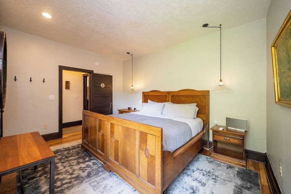 Bedroom #5 (second floor) with a king bed and a full bathroom shared with room #6. The bathroom is accessed through a short hallway that's shared with room #6.