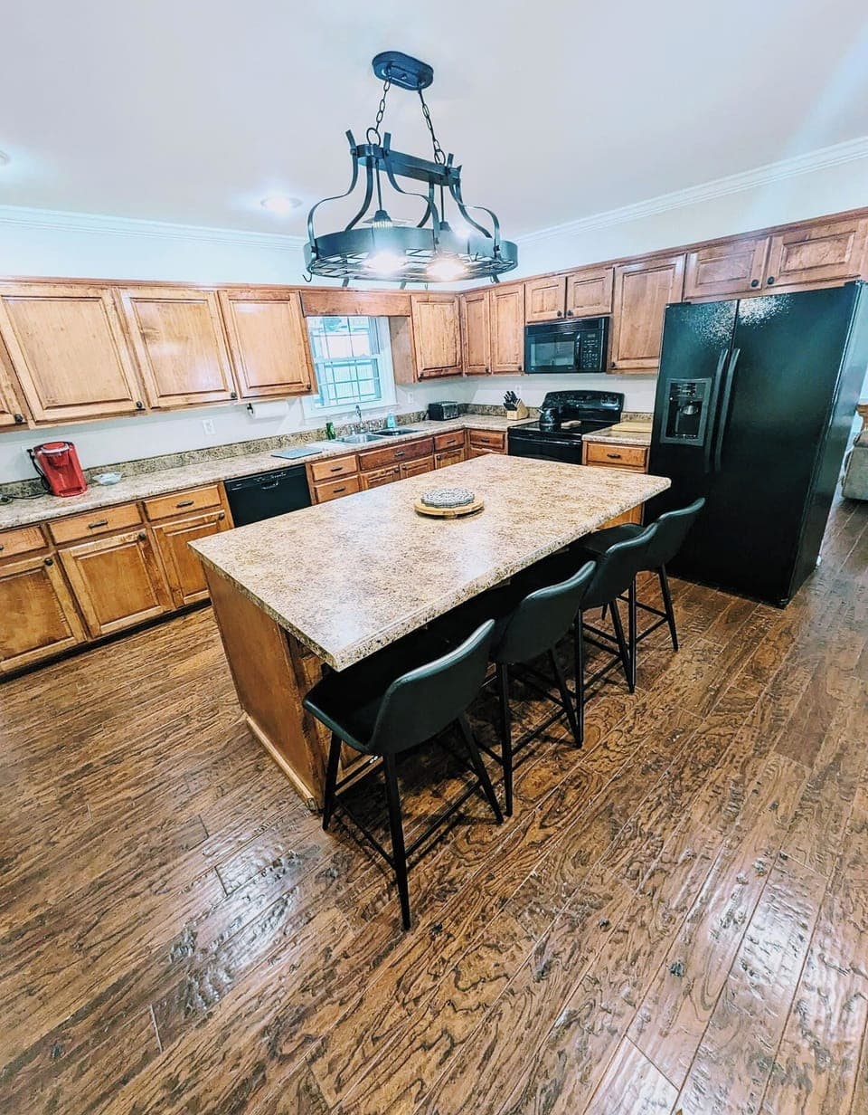 Spacious kitchen with island seating, great for gathering while meals are prepared.