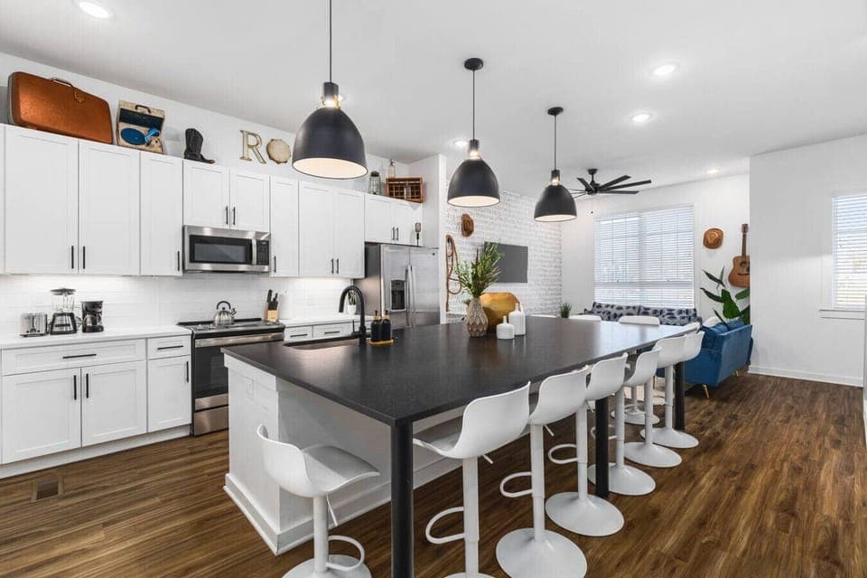 Massive kitchen island with seating for 10. High-end appliances including a wine cooler for a luxe cooking experience.