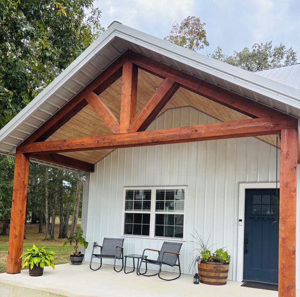 Cedar gable porch with rocking chairs and table. 