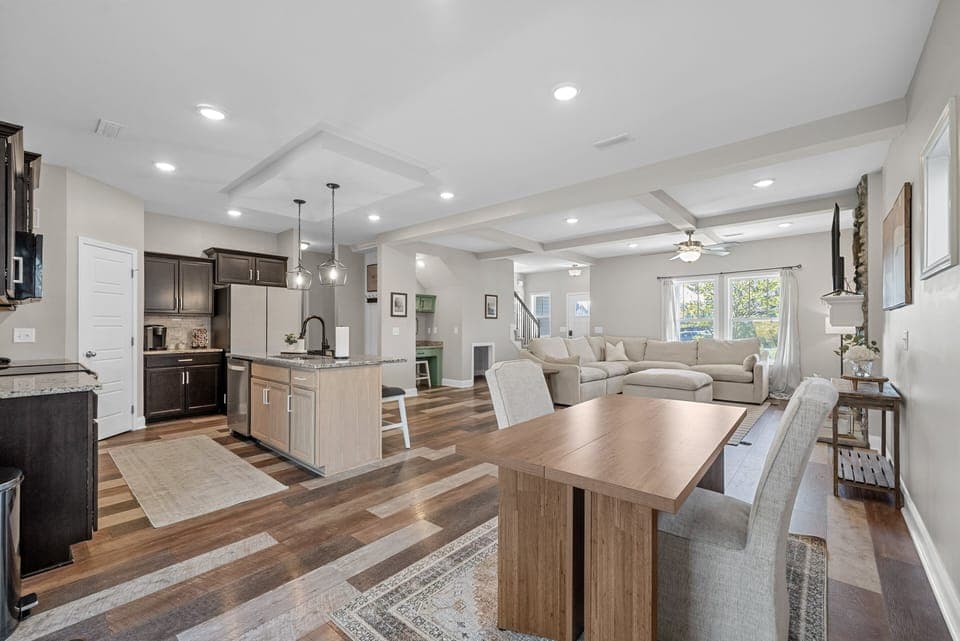 Open-concept layout showcasing dining area, kitchen, and living space