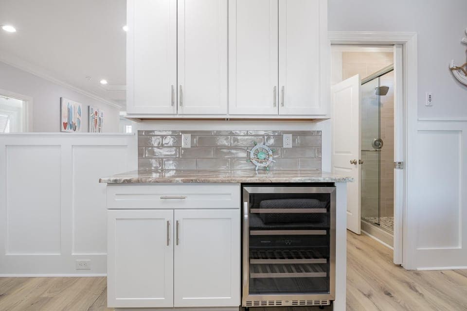 Chic kitchenette with sleek wine cooler and ample storage