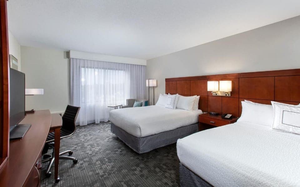 Unwind in a bright double-queen room with roomy workspace.