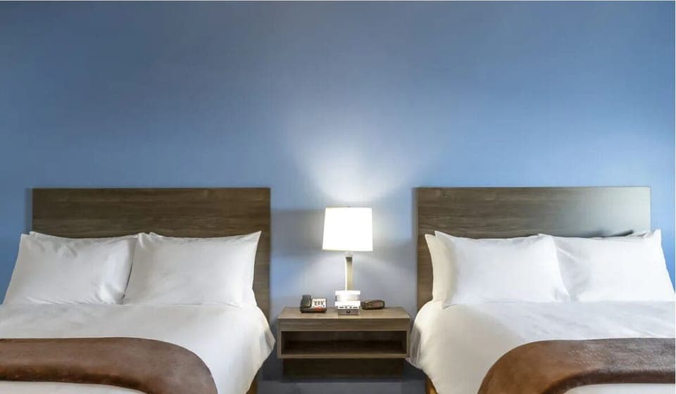Drift off under soft lighting between two hotel-fresh beds