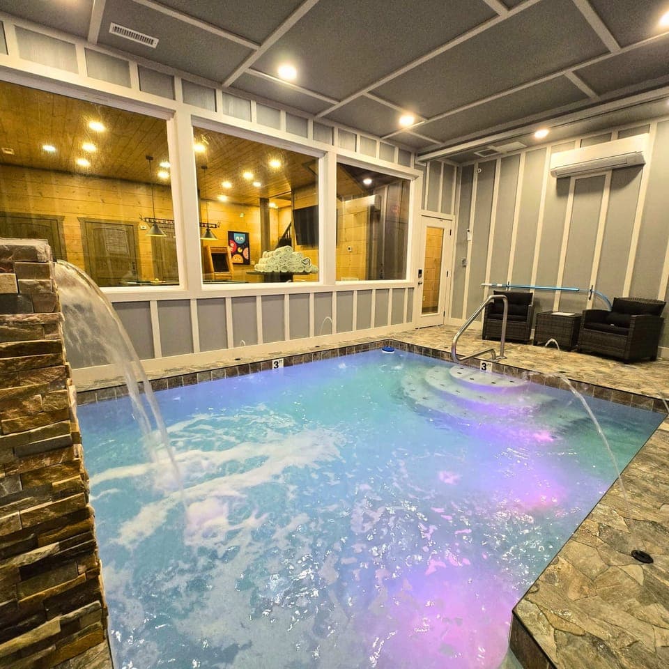 Splash in luxury with this stunning private indoor pool and adorned in color changing lighting, waterfall and jetted streamers