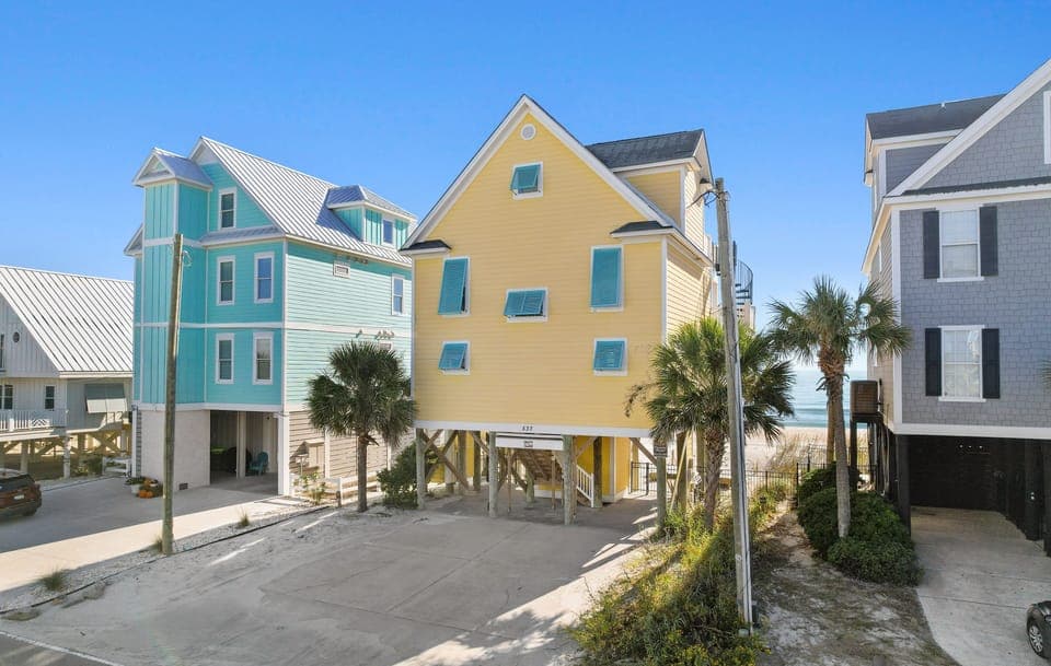 Colorful beachfront homes create a vibrant coastal community just steps from the shore.