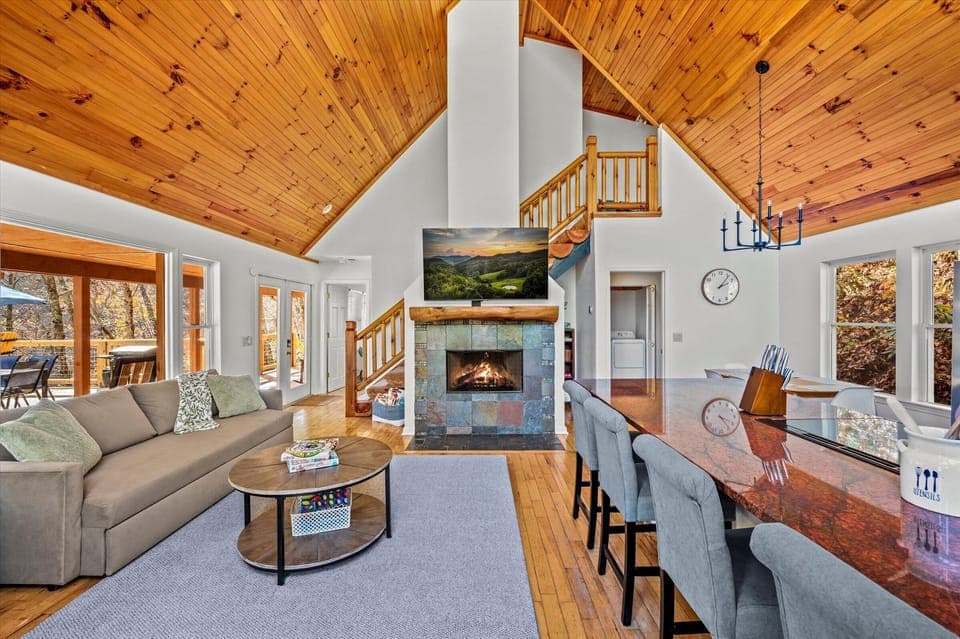 Vaulted ceilings, stone fireplace, and mountain views in the living room.