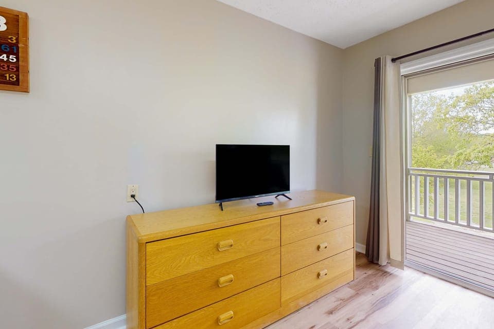 Inviting space with a TV, bright views, and easy porch access for relaxation!