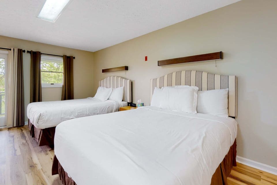 Dual beds with fresh linens, sunlit views, and a perfect space for relaxation!