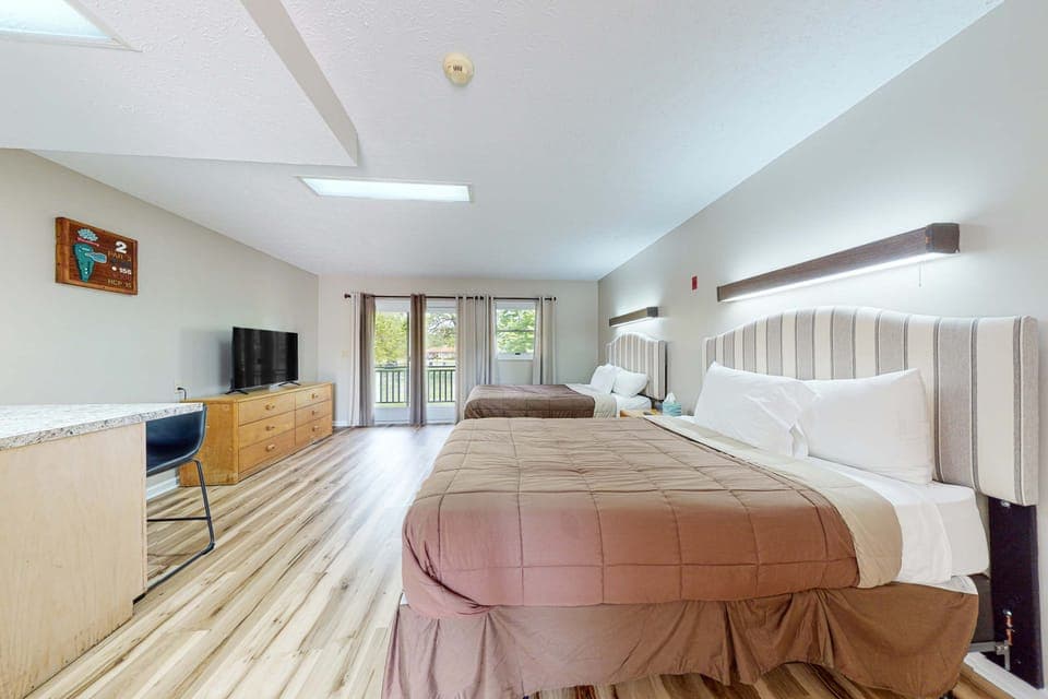 Spacious studio with 2 comfy beds, Smart TV, dresser, and balcony access. Perfect for families, couples, golf weekends, and extended stays. Bright, clean studio with room to spread out.