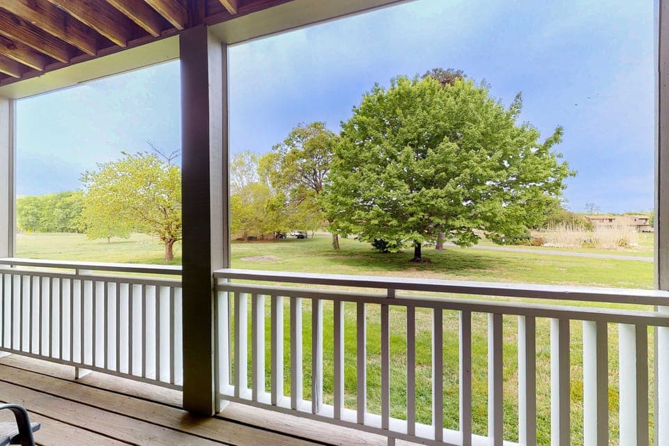 Covered balcony with peaceful green views. Perfect for morning coffee, fresh air, and relaxing after golf. Private outdoor space, resort-style setting, ideal for couples, families, and extended stays.