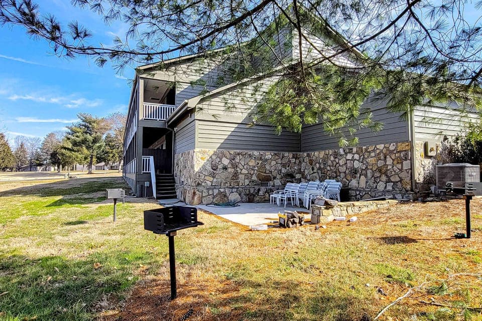 Outdoor grilling area with shared BBQ grills and seating, cookouts made easy! Great for groups, family trips, weekend getaway, resort grounds, picnic space, outdoor dining.
