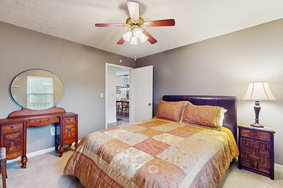Charming bedroom awaits. And, relax in style with a plush bed and vintage dresser in a serene getaway!