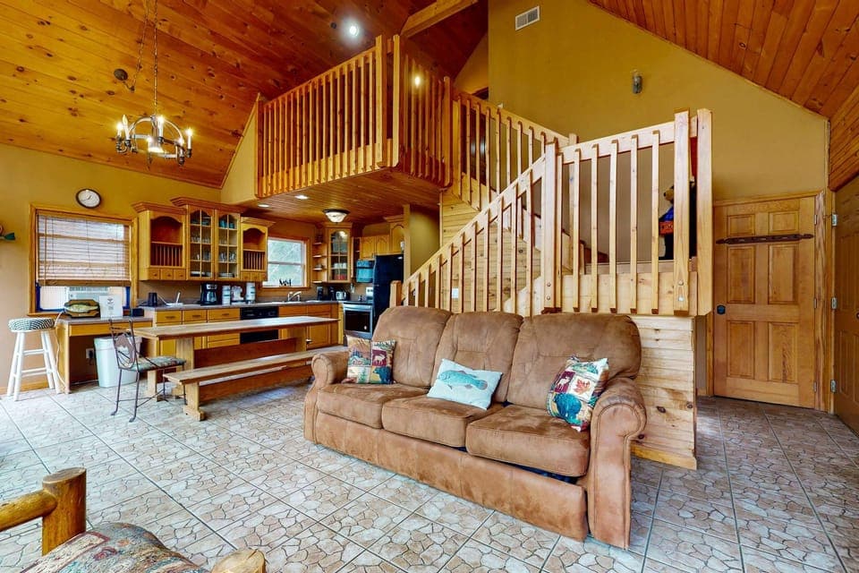 Sun-drenched space with rustic charm, inviting couch, and stunning wooden accents!