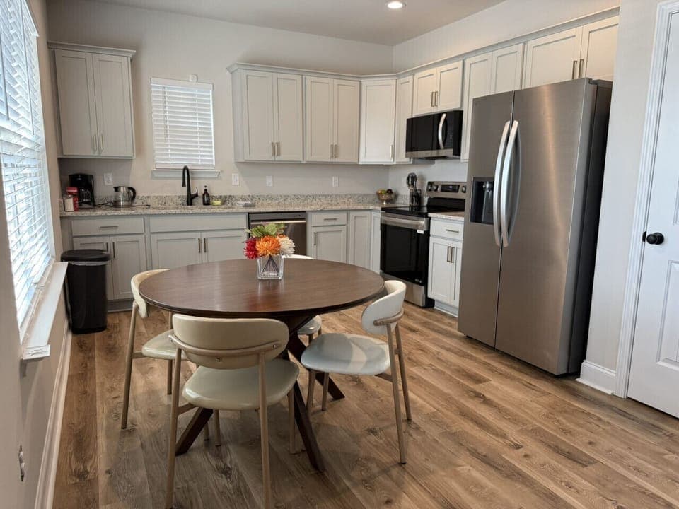 Cook and dine in style in this light-filled, open-plan space outfitted with granite countertops and seating for four.