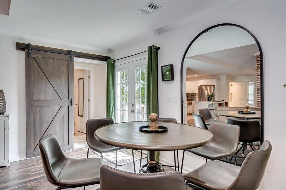 The mirror opens up the space, creating a bright and airy dining experience.