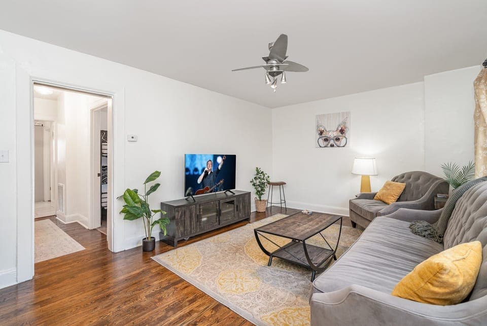 Unit 1: Bright and open living area with cozy furnishings and a smart TV.