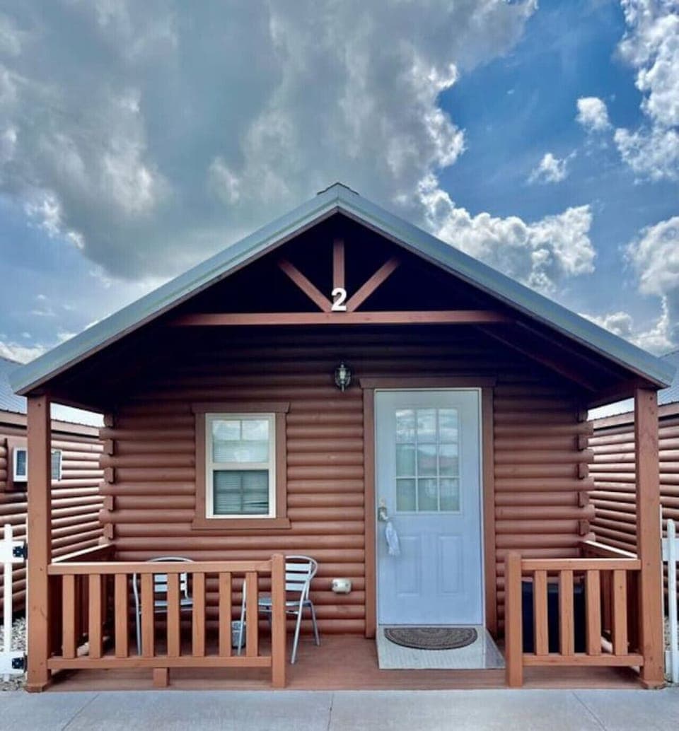 Charming cabin exterior with porch seating for morning coffee or evening chats.
