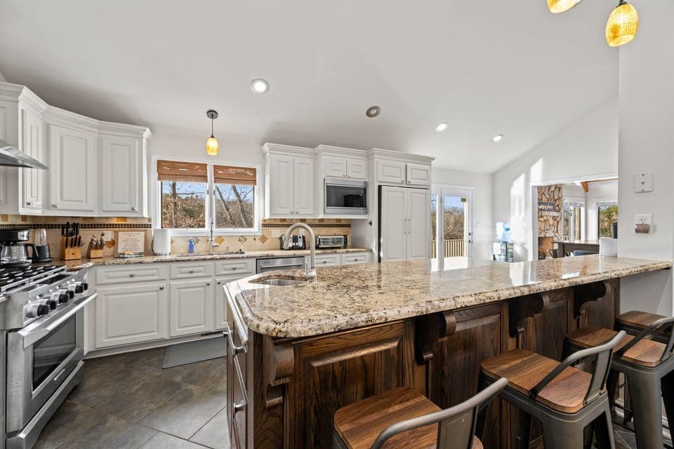 Open fully stocked kitchen off living space.