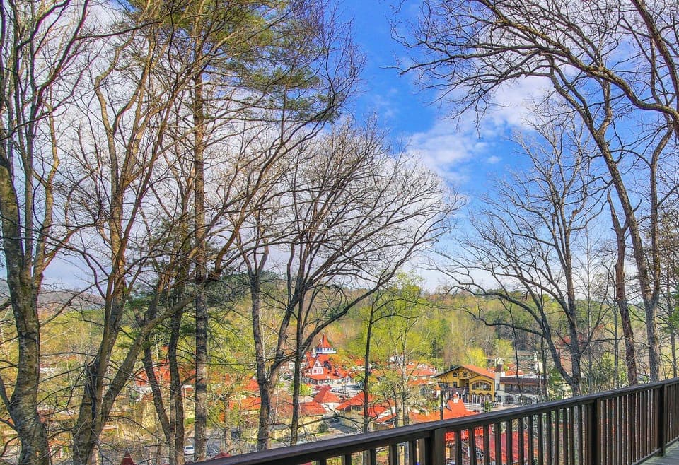 UPPER SUITE: Take in the town below from the private balcony off the living room, where treetops frame colorful rooftops and open skies. This inviting vantage point offers a peaceful place to pause, breathe, and enjoy the beautiful surroundings.