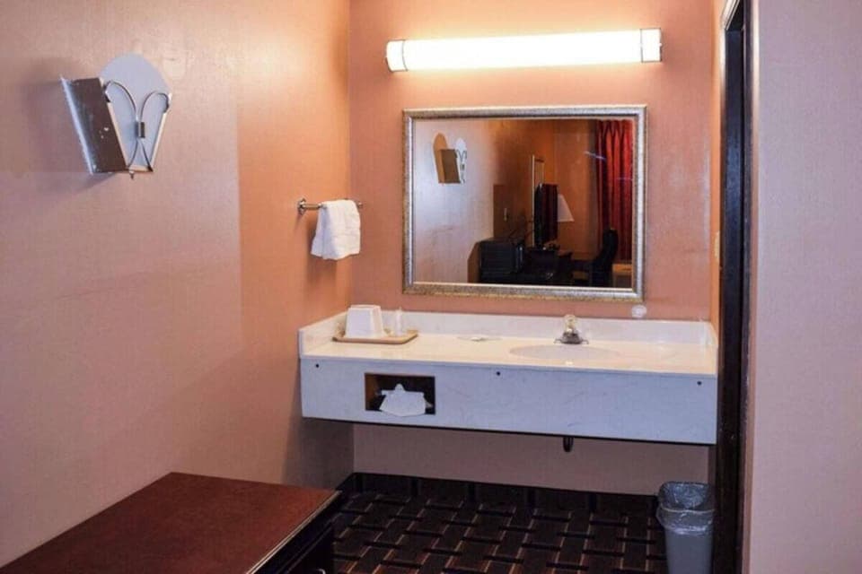 Get ready comfortably at the wide vanity under flattering lights.